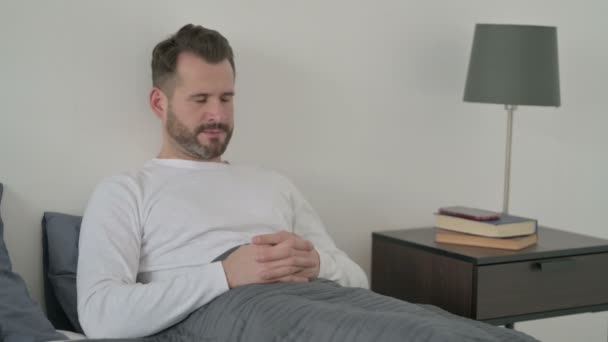 Man Feeling Worried while Sitting in Bed — Stock Video