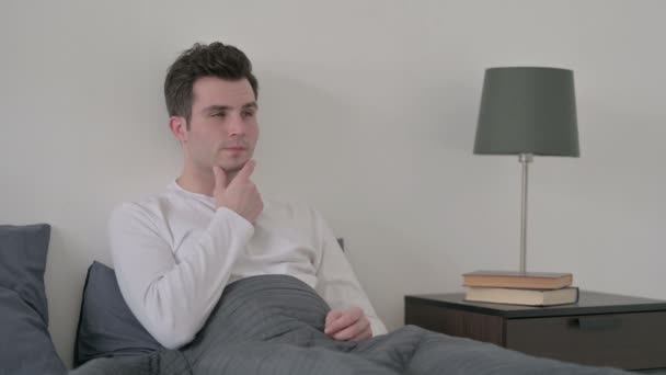 Man Thinking while Sitting in Bed — Stock Video