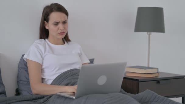 Žena reaguje na ztrátu na notebooku v posteli — Stock video