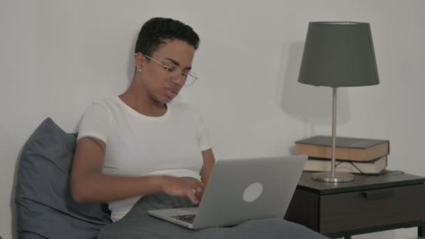 Yatakta dizüstü bilgisayar kullanırken Sırt Ağrısı Olan Afrikalı Kadın — Stok video