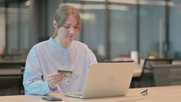 Молодая женщина делает онлайн оплаты отказа на ноутбуке в офисе — стоковое видео