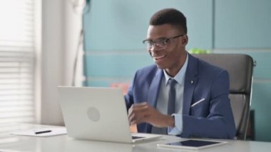 Genç Afrikalı İş Adamı Ofiste Dizüstü bilgisayar kullanırken Başarı Kutlaması