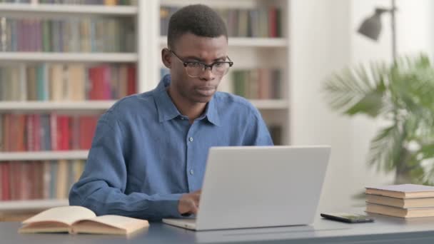 オフィスでラップトップを使用している間に若いアフリカ人男性の咳 — ストック動画