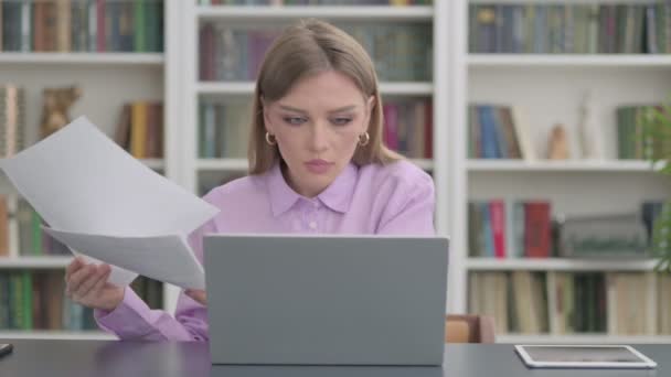 Woman with Laptop Celebrating Success while Reading Documents — Stock Video