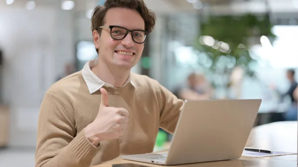 Young Man with Laptop showing Thumbs Up Sign — Photo