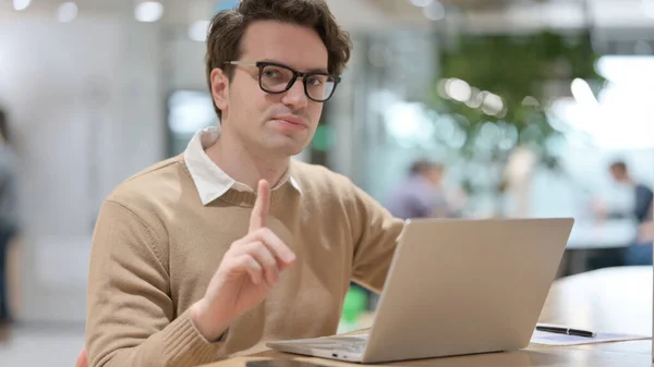 Young Man Showing No Sign while Working on Laptop — Foto de Stock