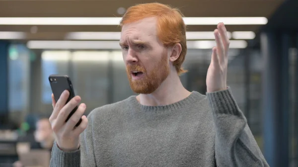 Young Man Reacting to Loss on Smartphone — Stock Photo, Image