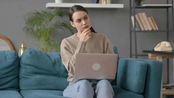 Woman with Laptop Reacting to Loss on Sofa — Stock Photo, Image