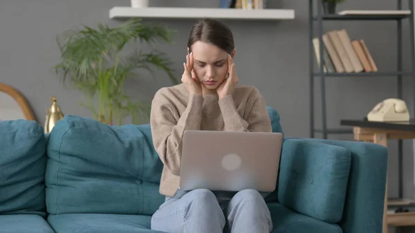 Woman with Laptop having Headache on Sofa — Stock Photo, Image