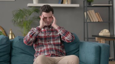 Koltukta oturan adamın başı ağrıyor. 