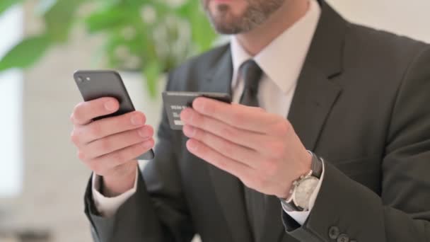 Primer plano del hombre de negocios de mediana edad que tiene pago en línea en el teléfono inteligente — Vídeos de Stock