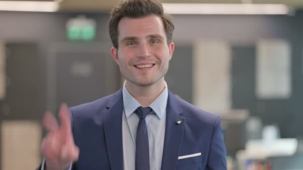 Portrait of Businessman showing Victory Sign with Finger — Stockvideo