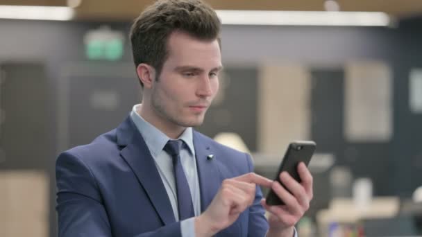 Portrait of Businessman Celebrating on Smartphone — Stock Video