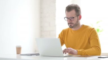 Man Feeling Shocked While using Laptop 