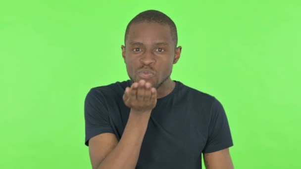 녹색 배경에 있는 젊은 아프리카 남자의 비행 키스 — 비디오