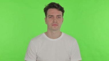 Yeşil arka planda dişi ağrıyan genç adam 