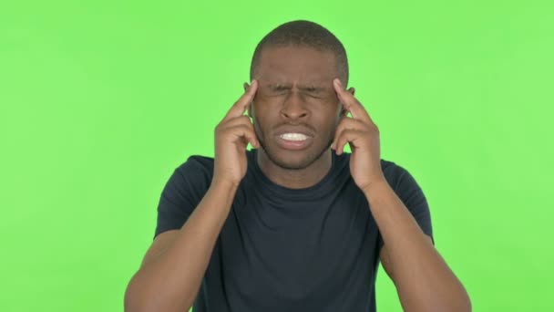Mladý Afričan s bolestí hlavy na zeleném pozadí — Stock video