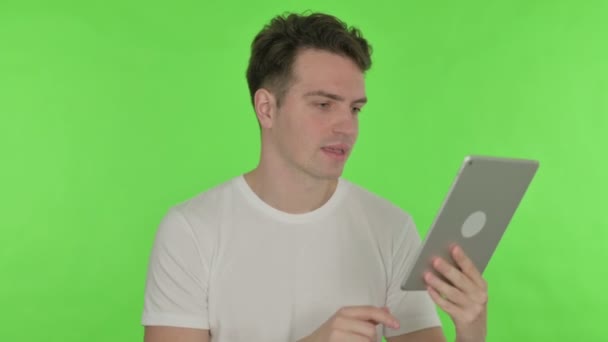 Vídeo Call on Tablet by Young Man on Green Background — Vídeo de Stock