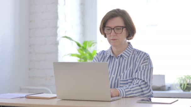 Απασχολημένη Ηλικιωμένη Γυναίκα Πληκτρολογώντας Στο Laptop Στο Γραφείο — Αρχείο Βίντεο