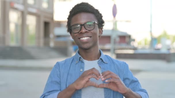Loving African Man Showing Heart Shape Hands Outdoor — Vídeos de Stock