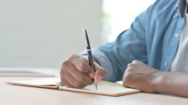 Close African Man Writing Notebook — Stockvideo
