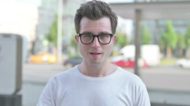 Casual Man showing Ok Sign with Finger Outdoor
