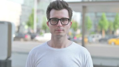 Portrait of Casual Man Looking at the Camera Outdoor