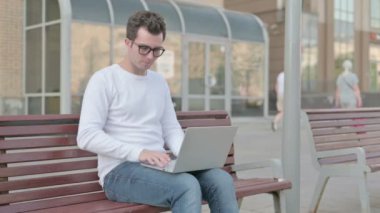 Casual Man Leaving Bench after Closing Laptop