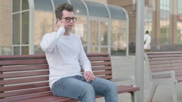 Casual Man Talking Phone While Sitting Outdoor Bench — Stockvideo