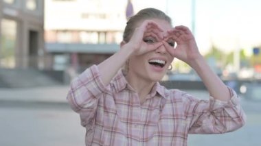 Casual Woman Looking Around with Handmade Binocular Outdoor