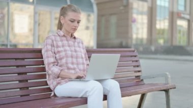 Casual Woman Leaving Bench after Closing Laptop