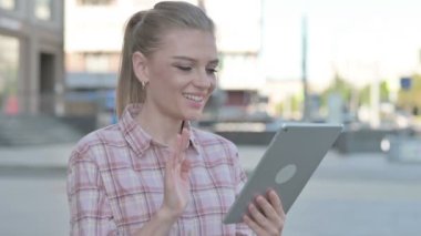 Video Call on Tablet by Casual Woman Outdoor