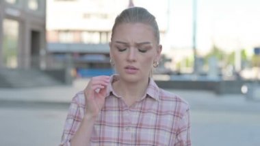 Portrait of Tense Casual Woman with Headache Outdoor