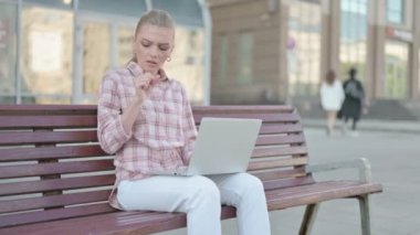 Coughing Casual Woman Using Laptop while Sitting Outdoor on Bench