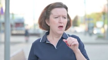 Senior Old Woman Coughing while Standing Outdoor