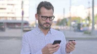 Adult Man Doing Online Shopping on Smartphone Outdoor