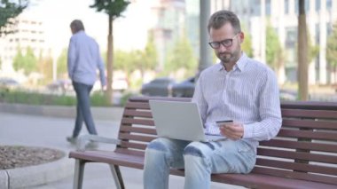 Adult Man making Successful Online Payment on Laptop 