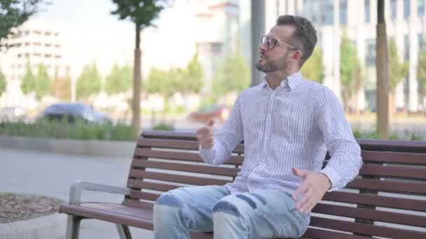 Angry Adult Man Feeling Frustrated While Sitting Outdoor Bench — Stockvideo