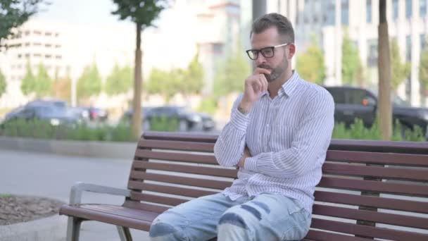 Pensive Adult Man Thinking While Sitting Outdoor Bench — Stockvideo