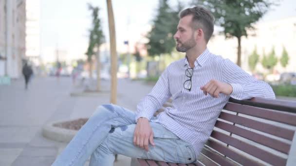 Adult Man Looking Camera While Sitting Bench — Stockvideo