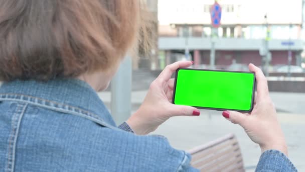 Senior Old Woman Holding Horizontal Smartphone Green Screen Outdoor — Video