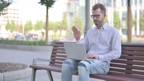 Adult Man Talking Video Call While Sitting Outdoor Bench — Stockvideo