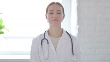 Female Doctor Shaking Head in Approval