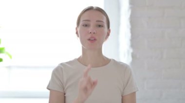 Young Woman Asking for Silence With Fingers on Lips, Quiet Please