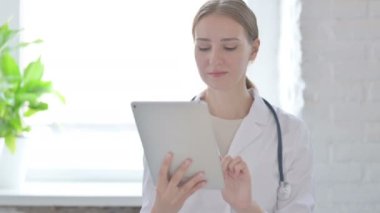 Female Doctor using Tablet for Work