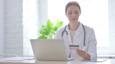 Female Doctor Doing Online Payment in Clinic