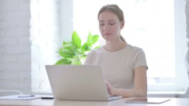 Young Woman Reacting to Loss While Working in Office