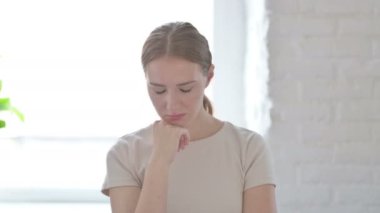 Tired Young Woman Sleeping while Sitting in Creative Office