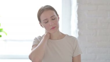 Young Woman in Pain Massaging Her Neck 