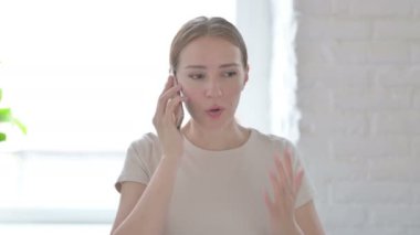 Displeased Young Woman Talking Angrily on Smartphone